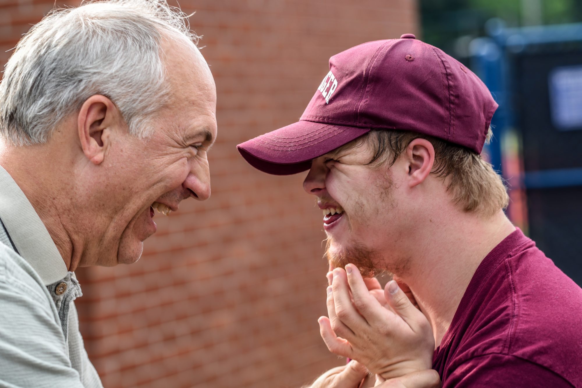 Disability Awareness Calendar, with disability awareness months: image of two man laughing at each other